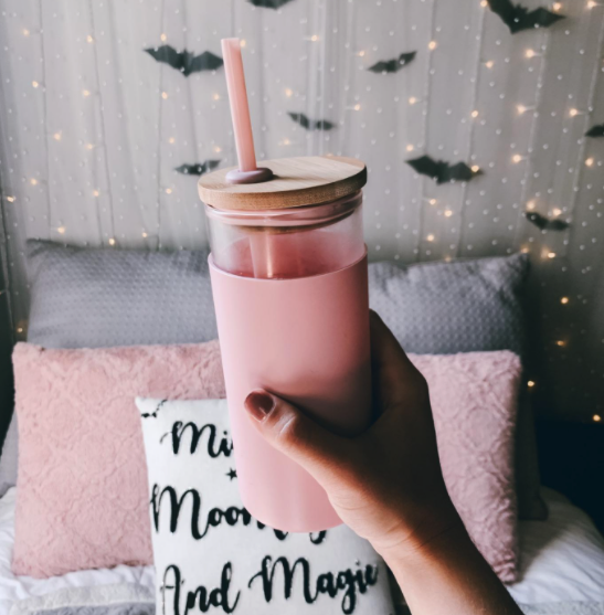 A person holding the pink tumbler