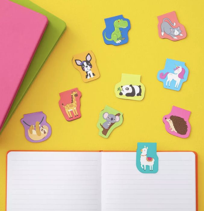 Animal-themed bookmarks paired with notebooks and an open journal
