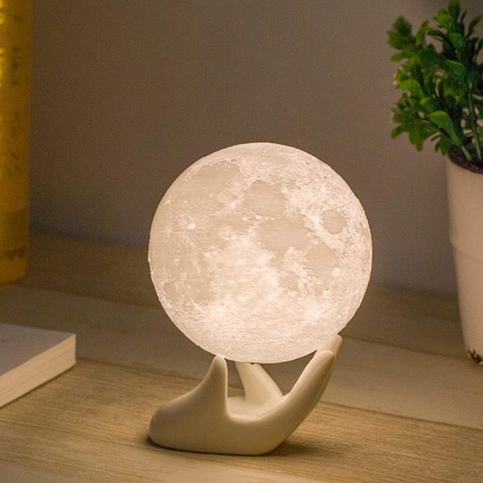 The moonlight resting on its hand-shaped stand