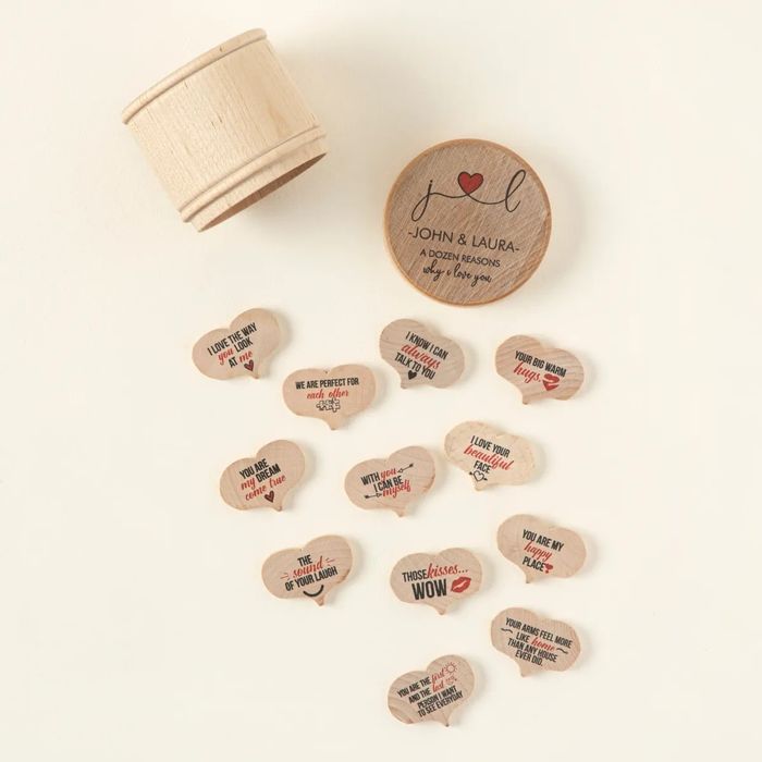 Wooden box containing heart-shaped tokens engraved with romantic phrases, such as 'I love you' and 'Those kisses... wow!'