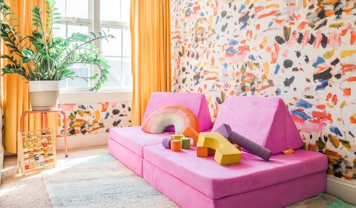 A vibrant pink Nugget couch.