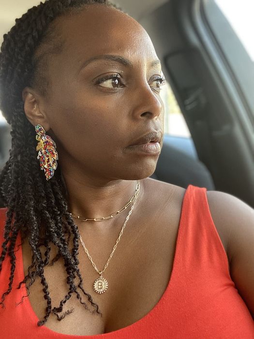 A reviewer wearing the layered necklace set