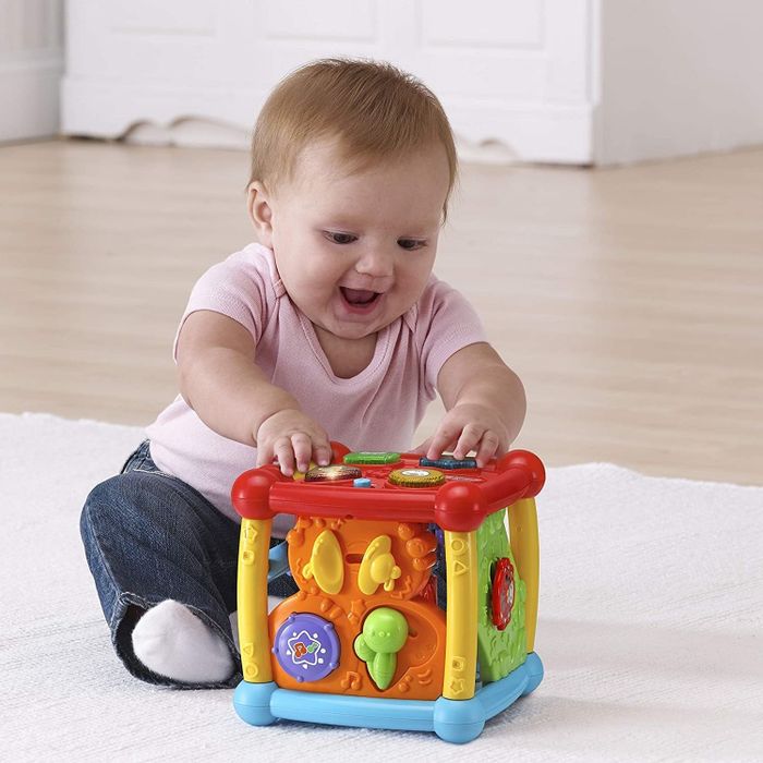 A baby interacting with the activity cube.