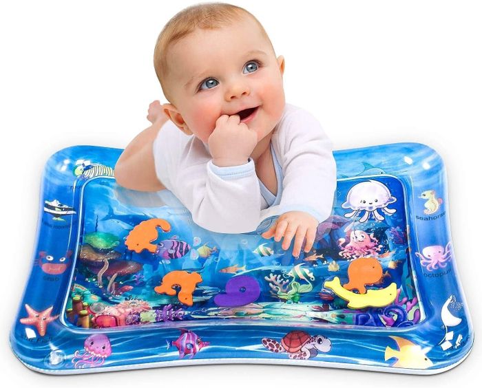 A baby enjoying time on the inflatable water mat.