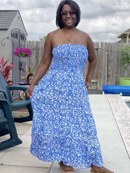 A reviewer wearing the strapless floral maxi dress.