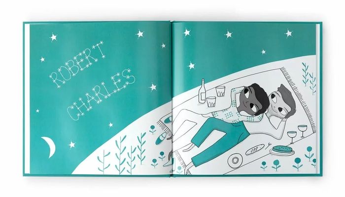 Illustrated open book depicting two characters gazing at the stars while enjoying a picnic with snacks and drinks. Text: 'Robert Charles.'