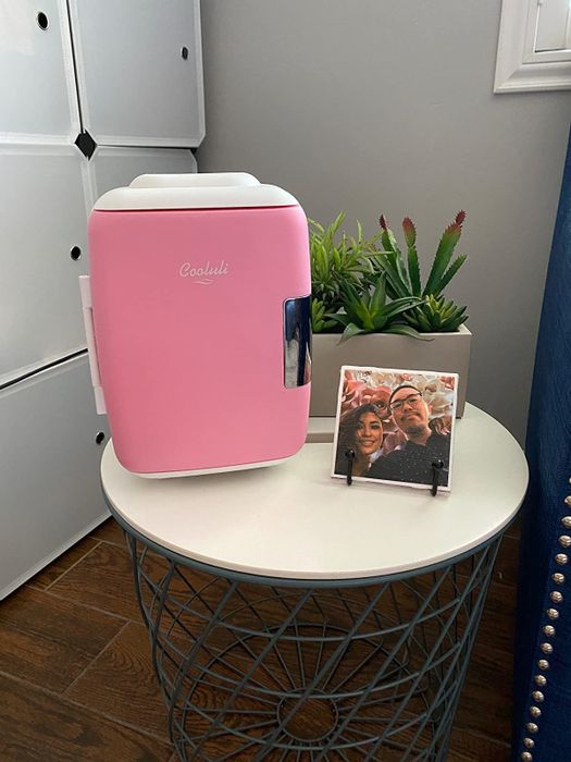A compact pink beauty fridge