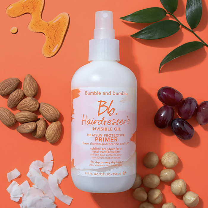 the bottle of product surrounded by its ingredients