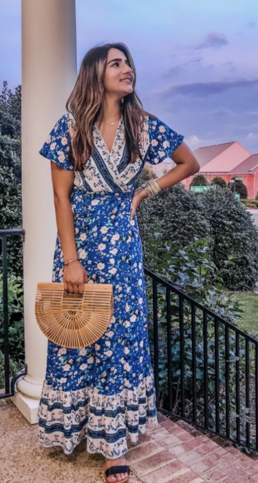 A reviewer showcasing the dress in a deeper shade of blue