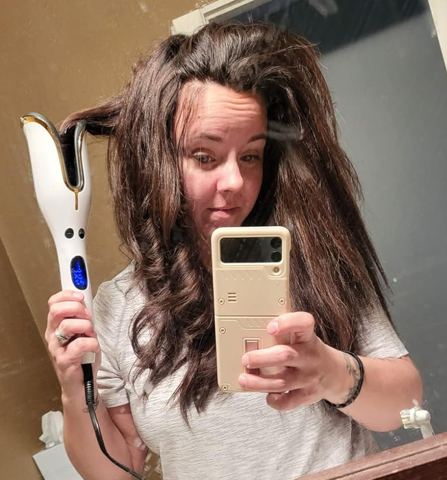 A different reviewer styling their hair with the tool