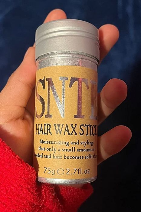 Reviewer holding the pomade stick
