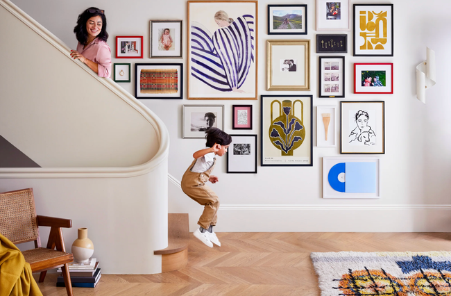 a child in front of a gallery wall