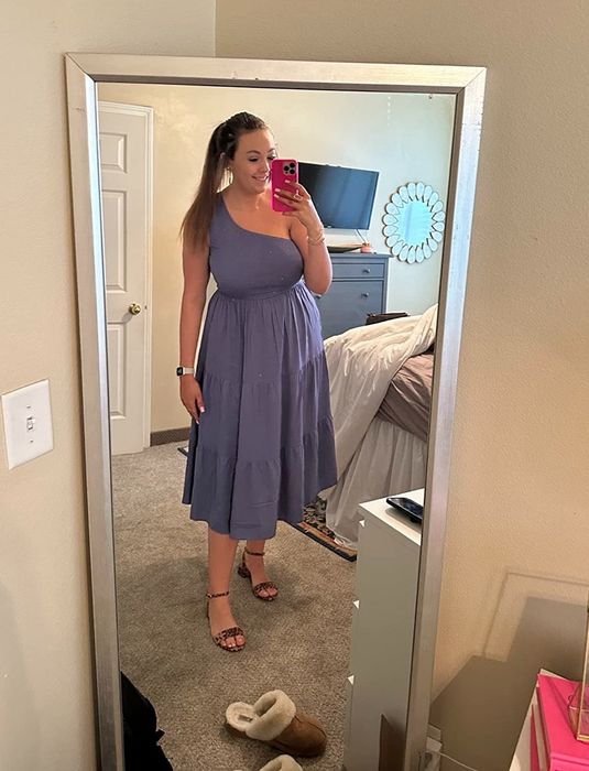 A reviewer rocking a purple one-shoulder maxi dress paired with leopard-print heels.