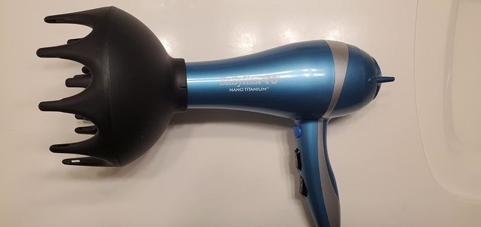 Review photo showing the diffuser attached to a hair dryer