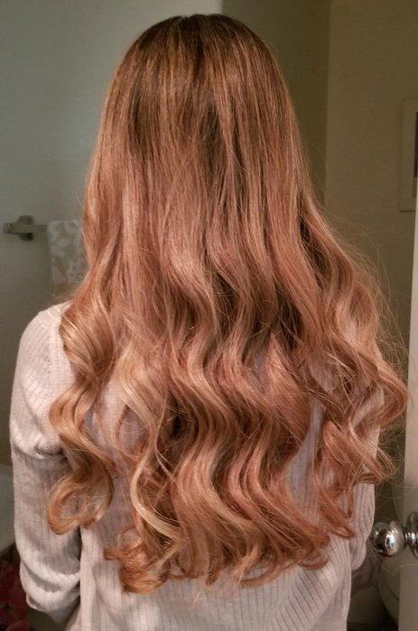 reviewer showing off long hair after curling with the styling tool