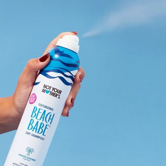A blue and white bottle of dry shampoo