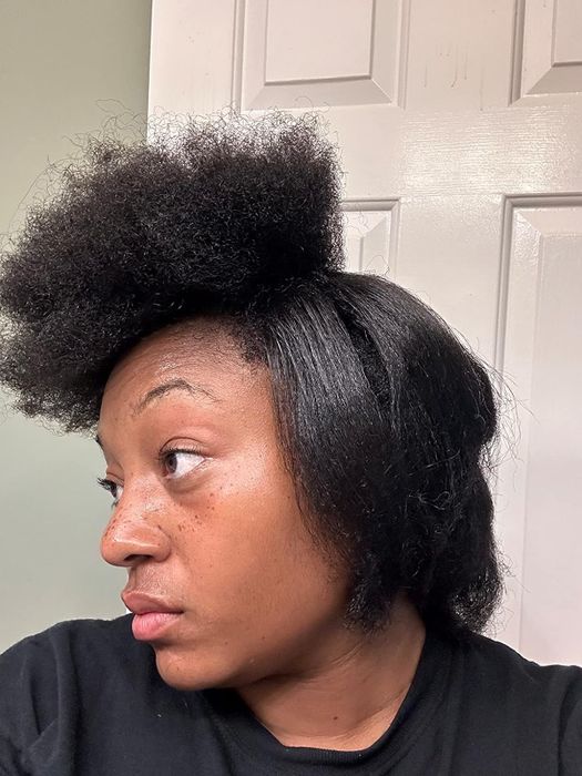 Reviewer showing a progress photo with one section of their hair perfectly straightened and the other section still in its natural, coarse texture
