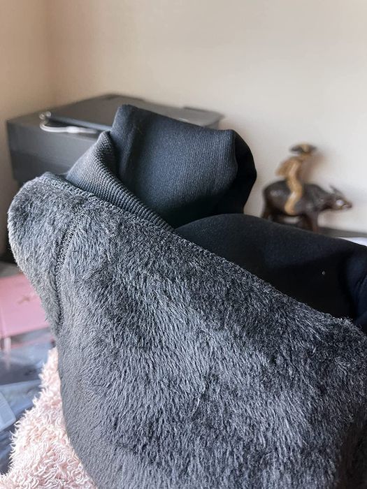 A reviewer displays a close-up of the soft fleece lining inside the gloves.