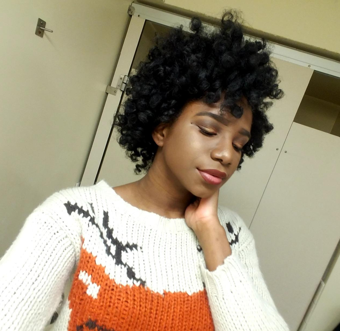The same reviewer displaying voluminous curls after using the rods (type 4C hair)