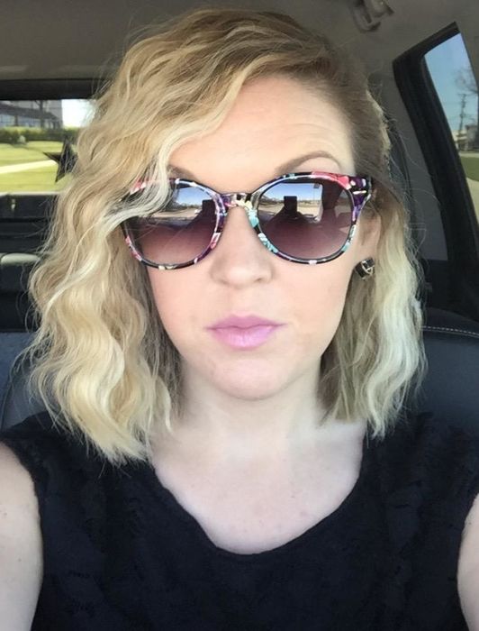 A reviewer with a stylish wavy bob haircut