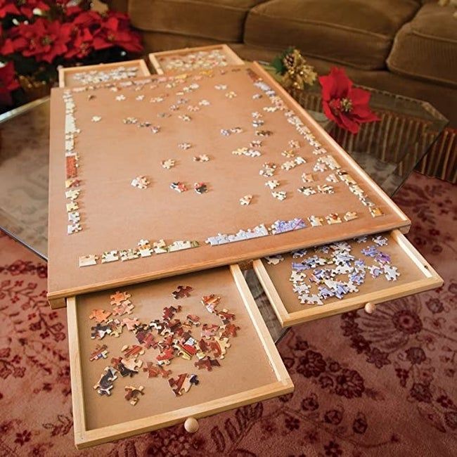 The puzzle plateau with its drawers open, holding the puzzle pieces inside