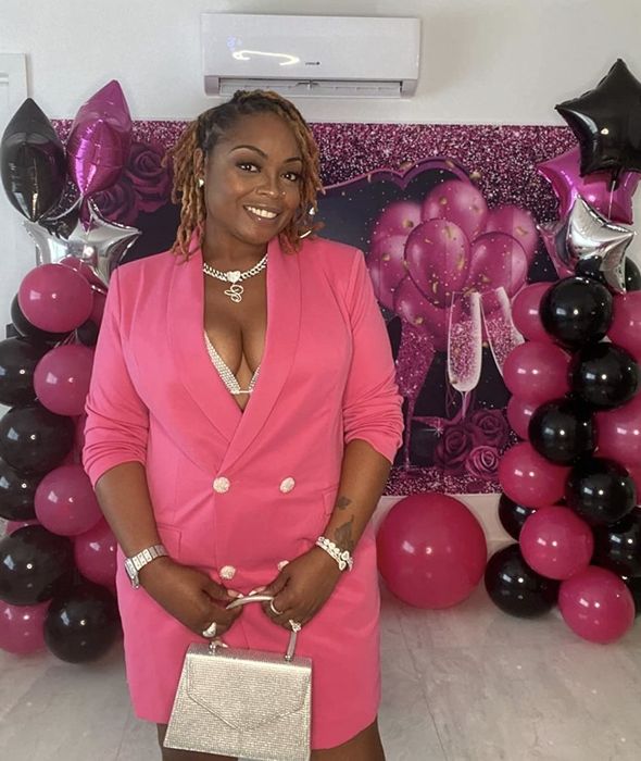 A reviewer showcases the pink blazer dress.