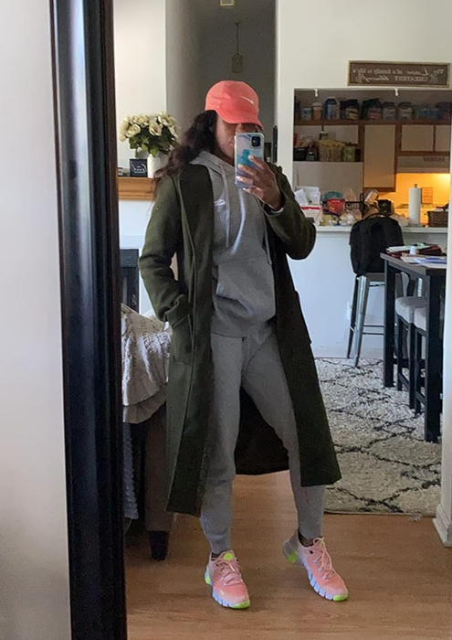 A reviewer donning an olive green outfit.