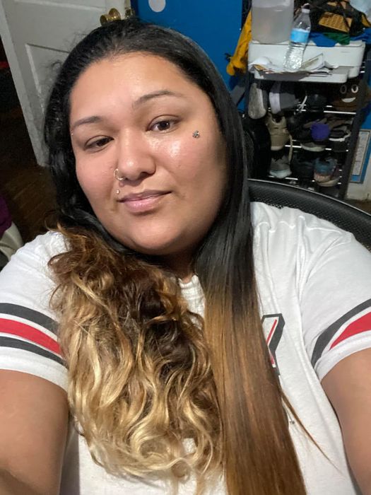 Another reviewer demonstrating the difference between one half of their wavy hair in its natural form and the other half straightened with the tool