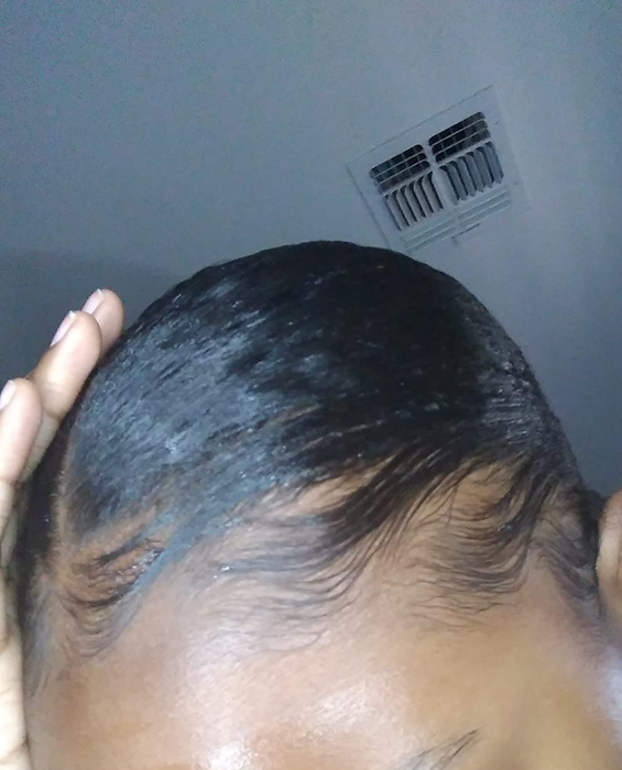 A close-up shot of a reviewer's perfectly slicked-down edges