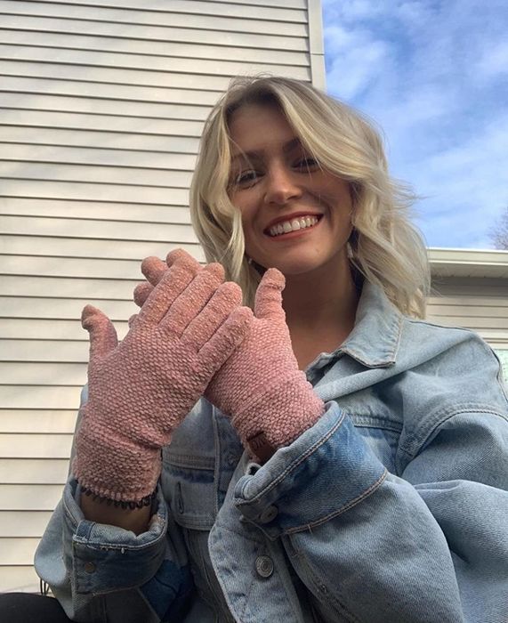 A reviewer rocking a pair of pink touchscreen gloves.