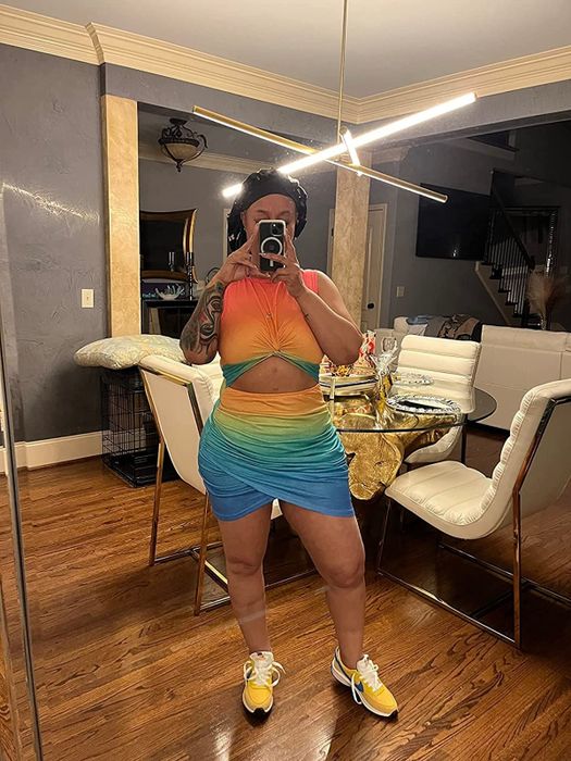 Reviewer rocking the rainbow sleeveless bodycon dress with a trendy cutout design.
