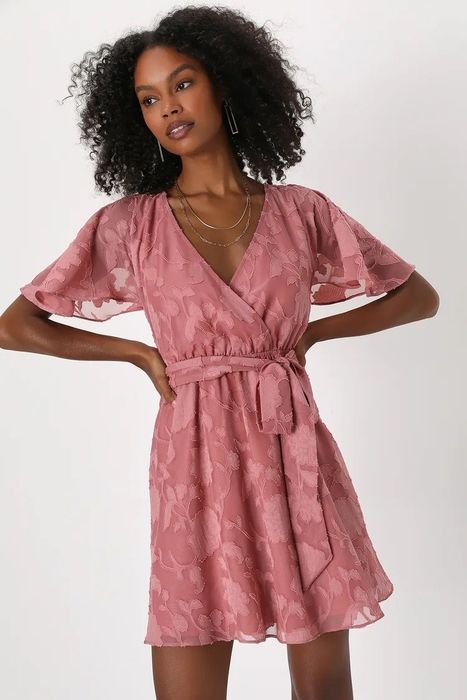 A model wearing a beautiful pink dress.
