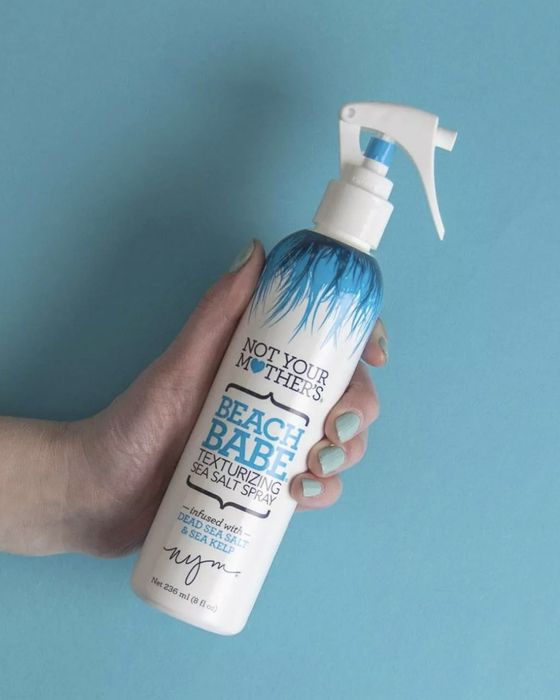 a person holding the spray