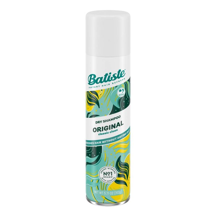 A bottle of dry shampoo with green, yellow, and white designs
