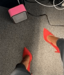 A gif showing a reviewer’s feet near a small pink space heater placed under their desk