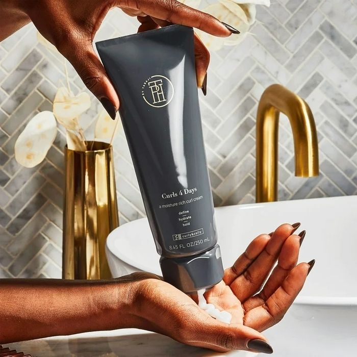 A model applying the grey tube of hair products