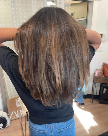 The same reviewer showcasing their hair after use, now super smooth and deeply moisturized.