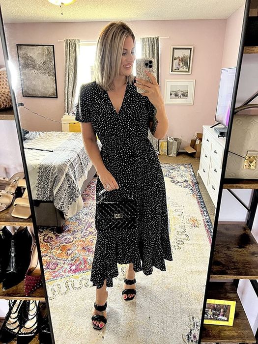Reviewer sporting the same dress in a chic black and white print.