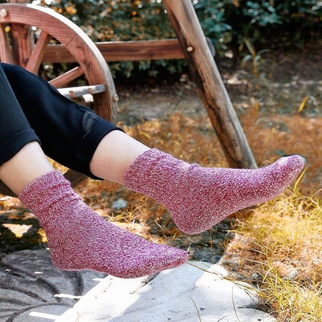a model stepping outside while wearing the red socks