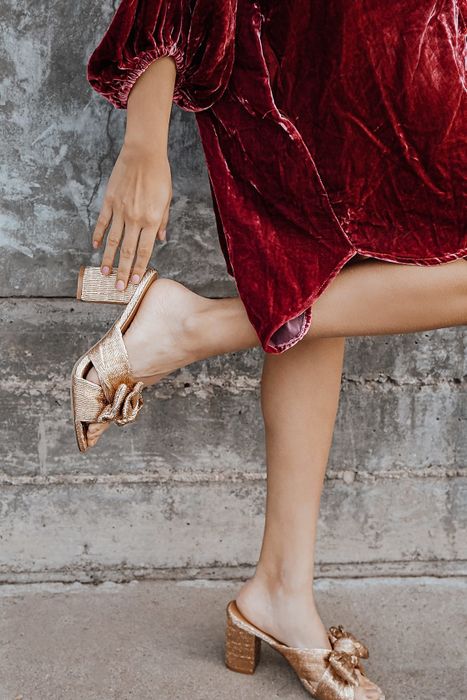 A model rocking a pair of gold shoes.