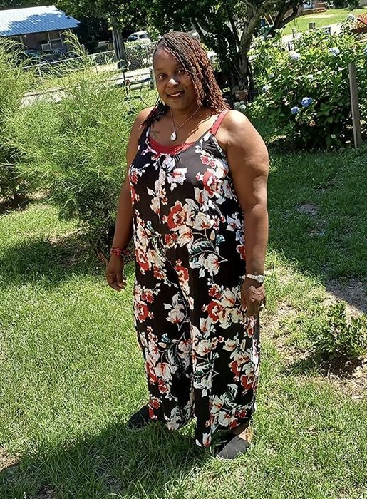 A reviewer styles the floral romper in black, adorned with red and white floral patterns.