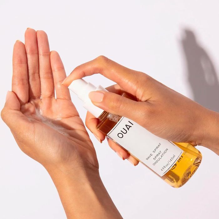 A model applying the wave spray to their palm