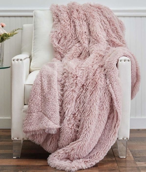 The throw blanket featuring long shaggy faux fur on one side and soft sherpa on the other