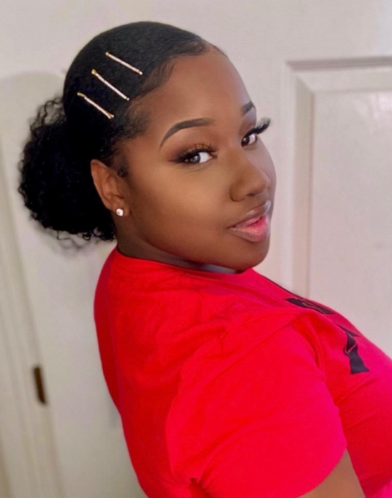 A reviewer with a sleek, slicked-back bun