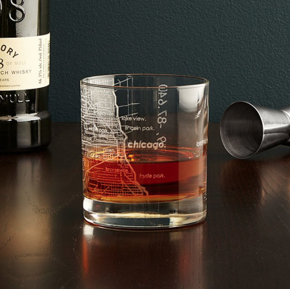 A cocktail served in a glass etched with a map of Chicago