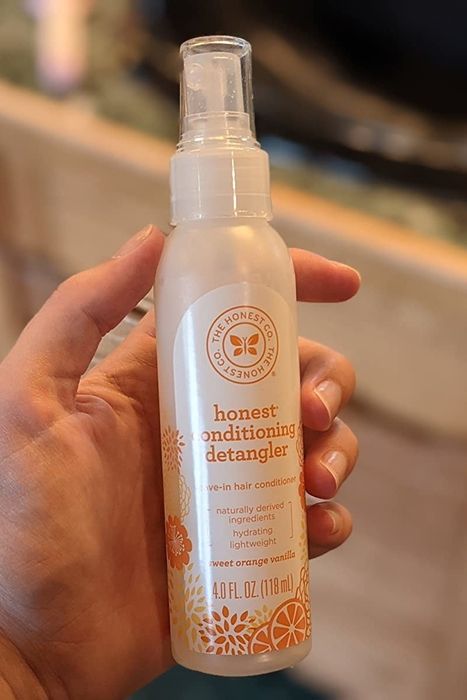 Reviewer holding a citrus vanilla spray.