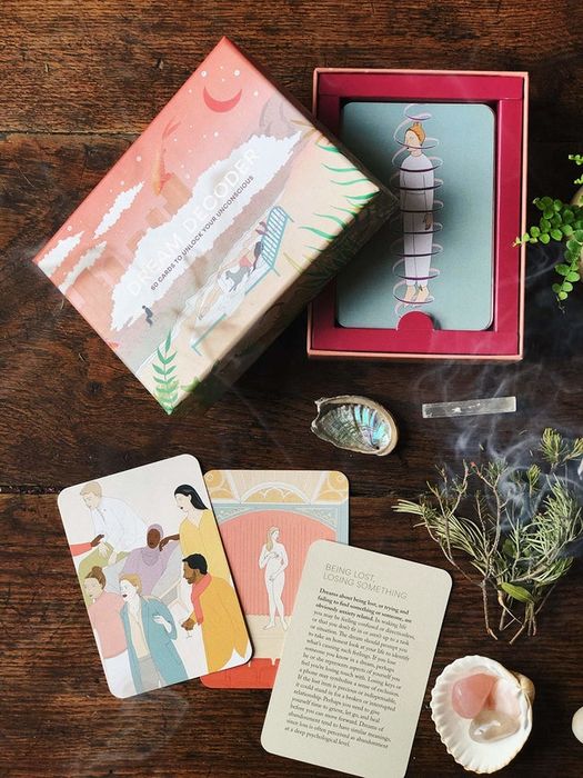 An illustrated deck of Dream Decoder cards with detailed dream interpretations on the backs