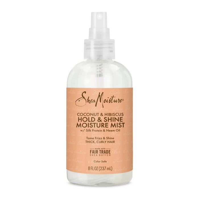 A clear and orange bottle of hair product
