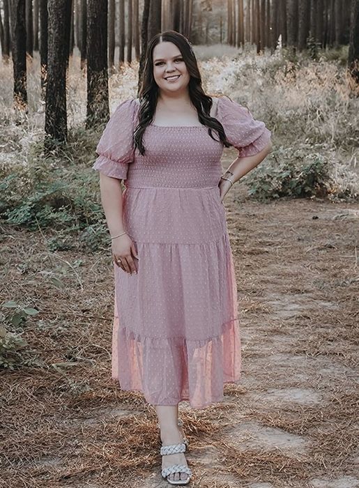 A reviewer is wearing the dress in a delicate blush shade.
