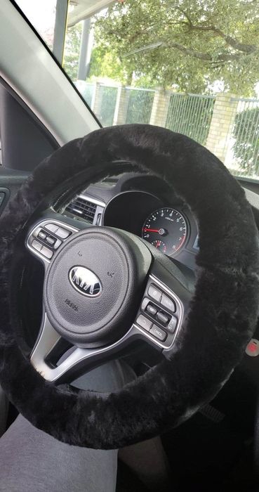 A reviewer features the black cover on their steering wheel.